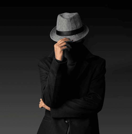 man with face covered by hat and hand