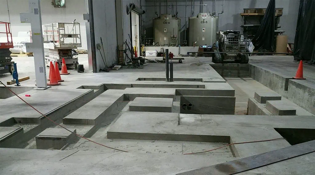 Concrete pads for equipment in manufacturing facility