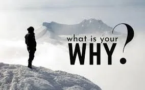 What is your why? Man standing on mountain in fog.